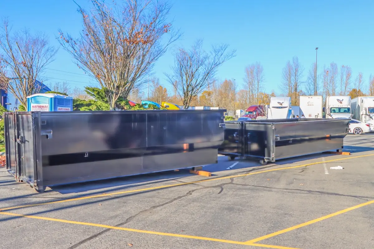 Professional dumpster rental service with roll-off container on residential driveway in Lackland AFB